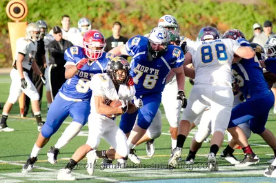 Andrew Walls, No. 76 in a blue North jersey, blocking as a ball carrier in white runs past during the 2012 Les Schwab Bowl all-star game