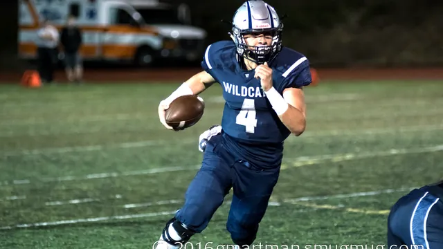 Connor Neville runs with the ball at night