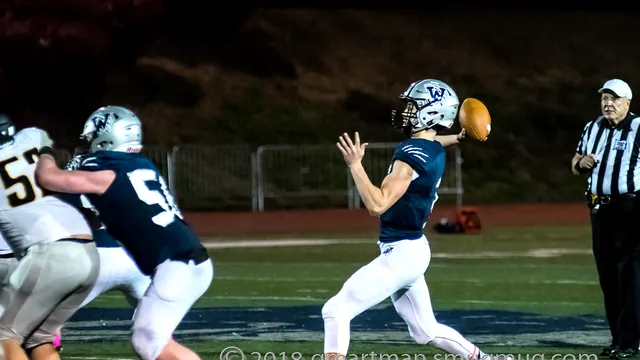 Nathan Overholt throws a pass at night