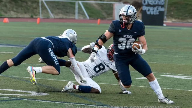 Mark Wiepert blocks as Jacob Ogden runs