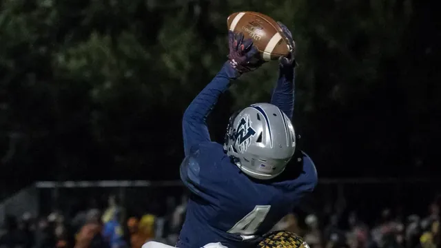 Cooper Hiday goes up for a catch at night
