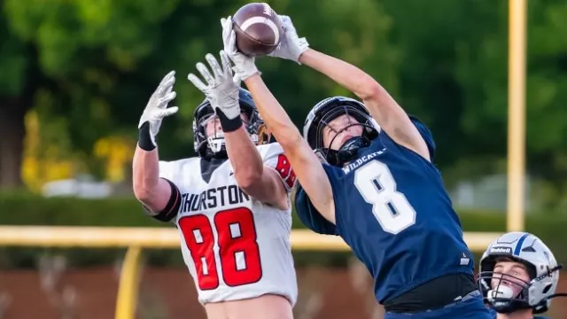 Lucas Larson intercepts a pass over a Thurston receiver