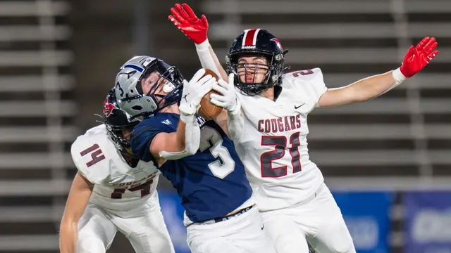Nick Crowley, Wilsonville No. 3, catching the ball between Mountain View defenders No. 14 and No. 21