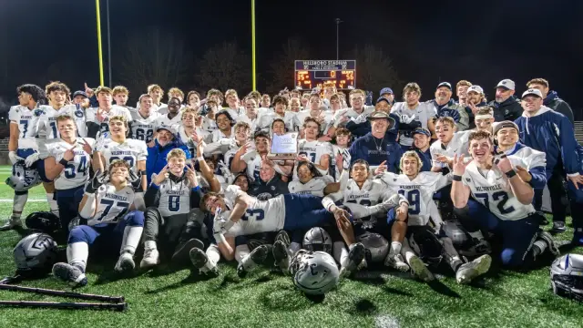 Wilsonville team photo with the 5A championship trophy at Hillsboro Stadium