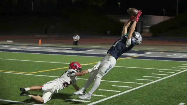 Cavan Rogers dives for a catch at night