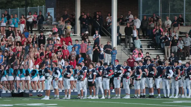 The team and home crowd during the national anthem